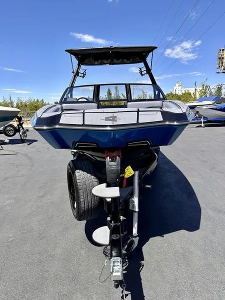 Slide: The Image of 2024 Axis A225 boat on trailer, front view, under clear blue sky. - 4