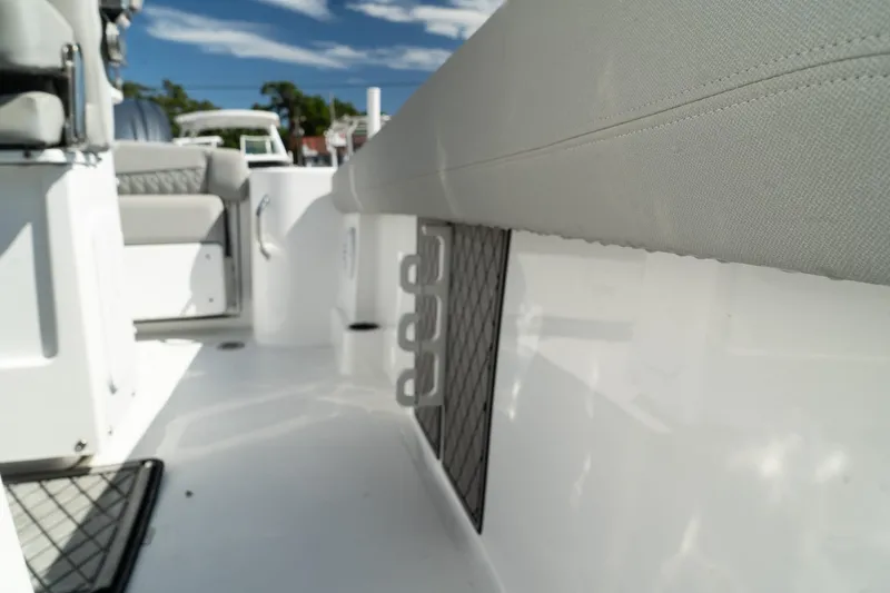 Slide: The Image of 2023 Wellcraft 242 Fisherman boat interior with cushioned seating and storage compartments. - 19