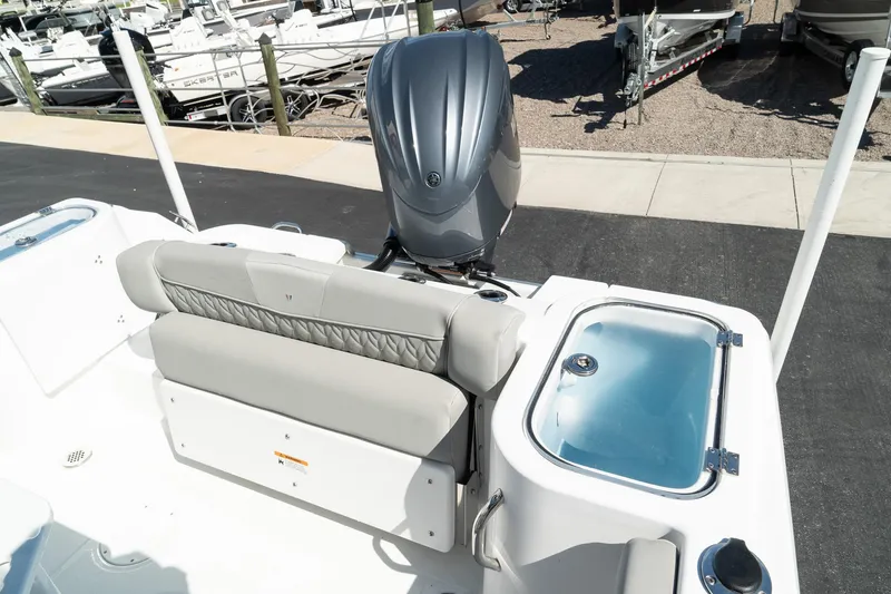 Slide: The Image of 2023 Wellcraft 242 Fisherman boat with outboard motor and seating area. - 22