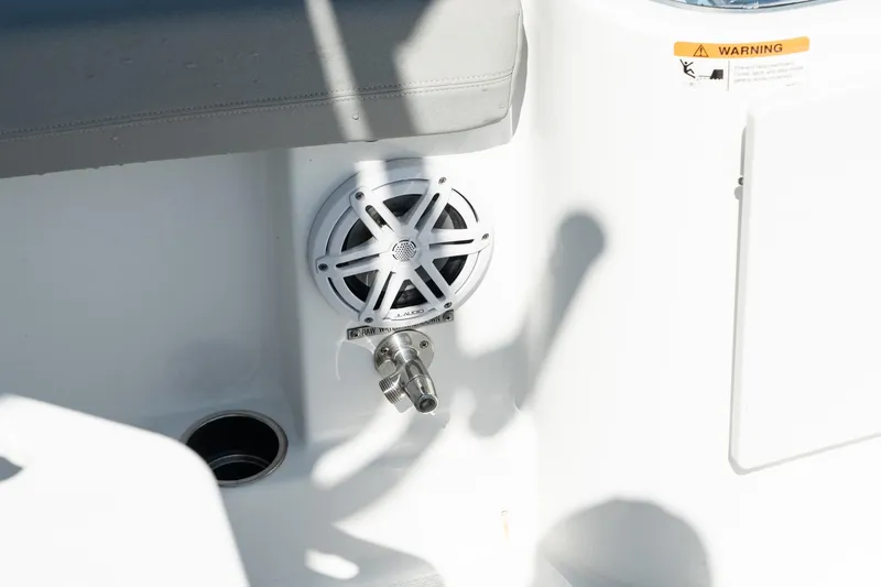 Slide: The Image of Close-up of the 2023 Wellcraft 242 Fisherman boat's speaker and water outlet. - 23
