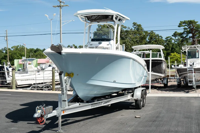 Slide: The Image of 2023 Wellcraft 242 Fisherman boat on a trailer in a marina. - 4