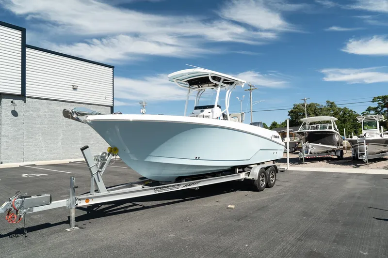 Slide: The Image of 2023 Wellcraft 242 Fisherman boat on a trailer in a parking lot. - 5