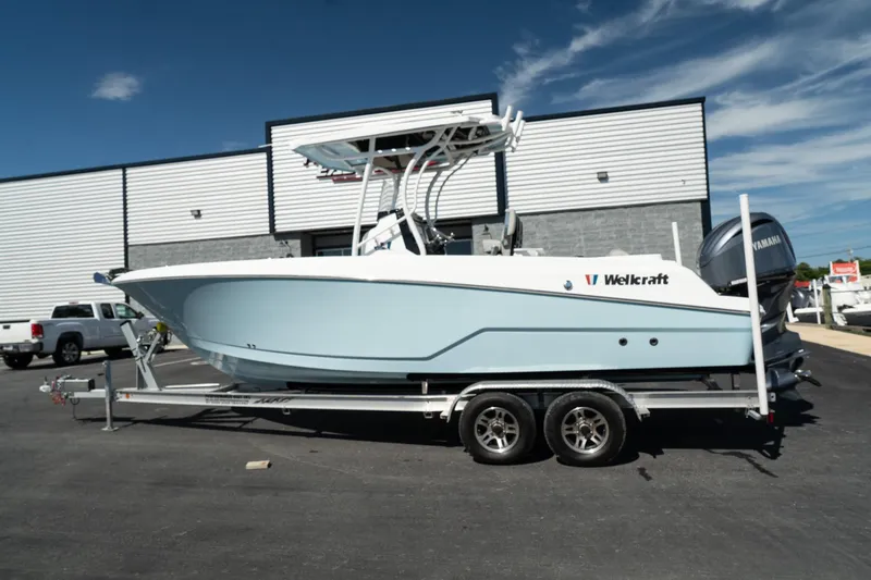 Slide: The Image of 2023 Wellcraft 242 Fisherman boat on a trailer in front of a building. - 6