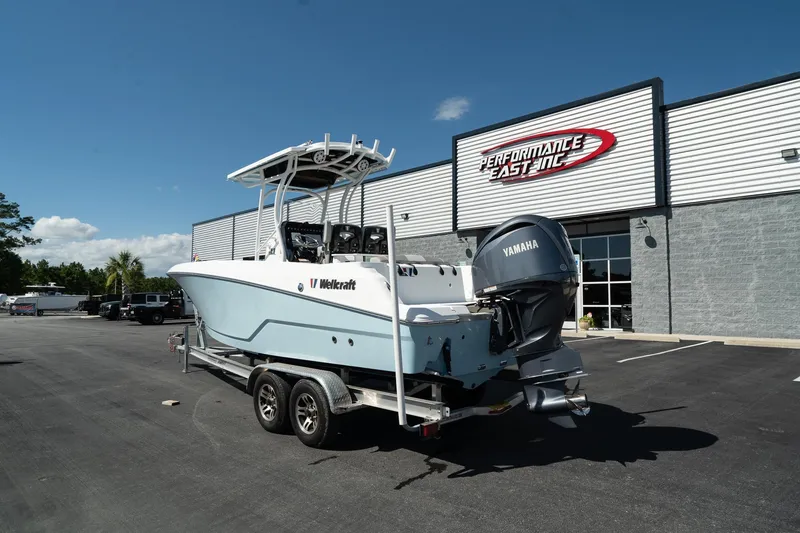 Slide: The Image of 2023 Wellcraft 242 Fisherman boat on trailer outside dealership. - 7