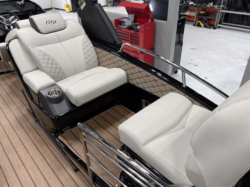 Slide: The Image of 2024 Manitou 25 LX SRW Dual Engine boat interior with luxurious seating. - 11