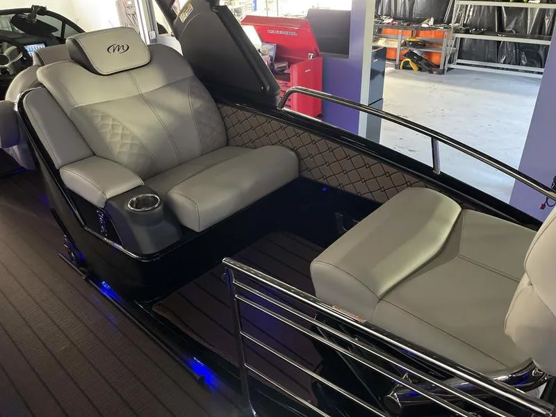 Slide: The Image of 2024 Manitou 25 LX SRW Dual Engine boat interior with luxurious seating. - 9