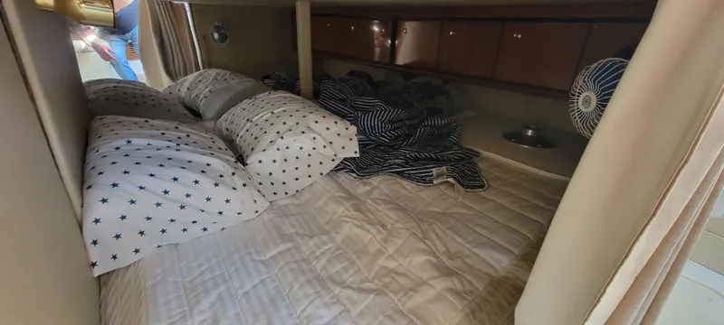 Slide: The Image of 2007 Fountain 38 Express Cruiser cabin with bed and pillows. - 15