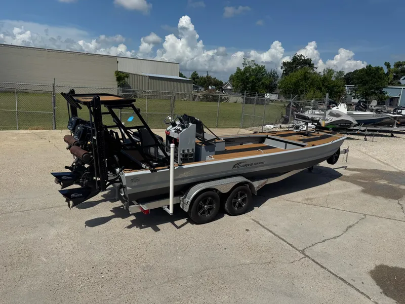Slide: The Image of 2023 Pro-Drive 22x72 SBX boat on trailer in outdoor lot. - 12