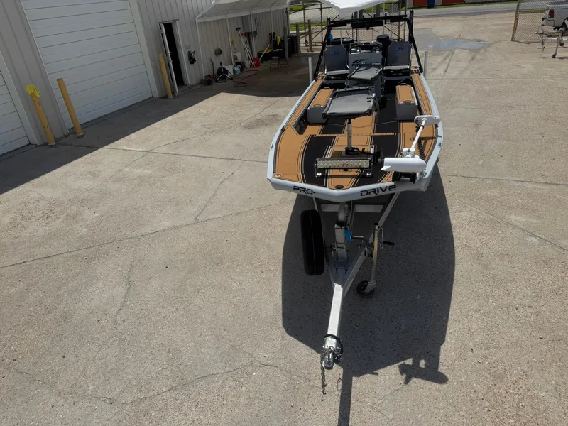 Slide: The Image of 2023 Pro-Drive 22x72 SBX boat on trailer in outdoor setting. - 18