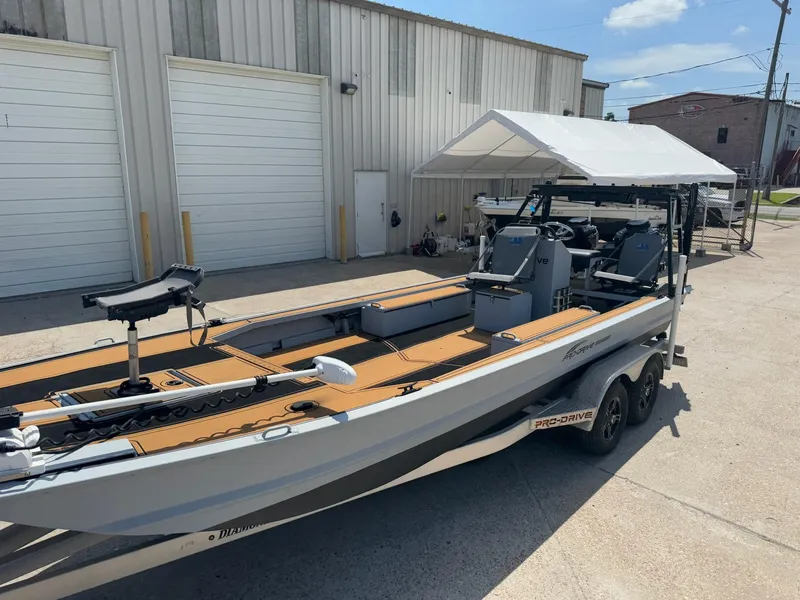Slide: The Image of 2023 Pro-Drive 22x72 SBX boat parked outside a warehouse on a sunny day. - 19