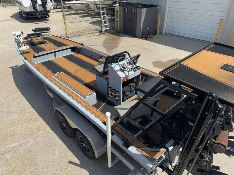 Slide: The Image of 2023 Pro-Drive 22x72 SBX boat with dual-axle trailer in a storage yard. - 20