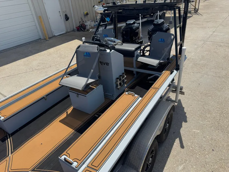 Slide: The Image of 2023 Pro-Drive 22x72 SBX boat on trailer, featuring dual motors and seating. - 21