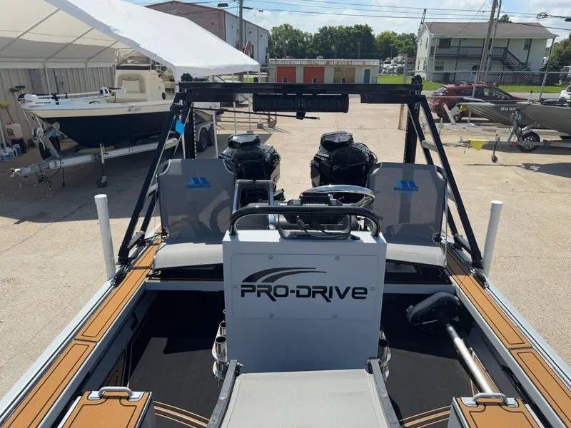 Slide: The Image of 2023 Pro-Drive 22x72 SBX boat with dual engines, parked outdoors. - 25