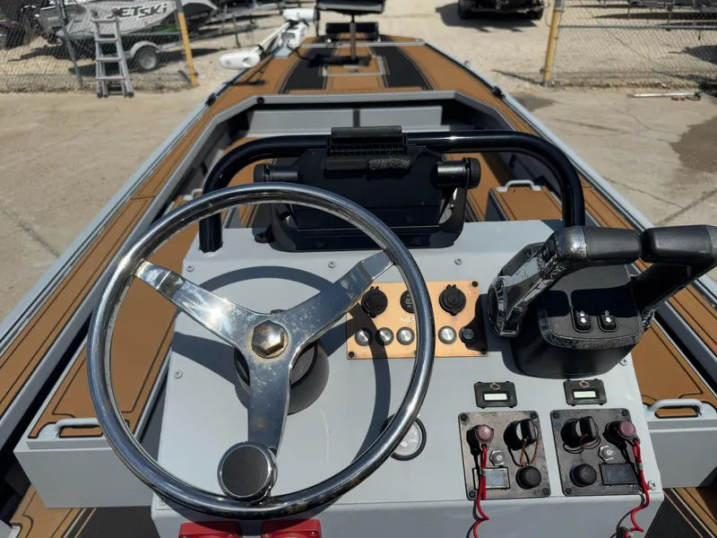 Slide: The Image of 2023 Pro-Drive 22x72 SBX boat dashboard with steering wheel and controls. - 28