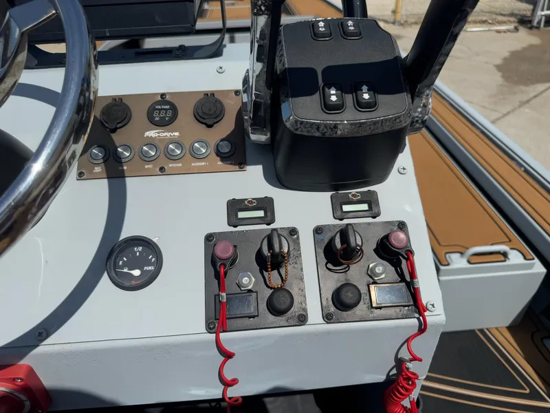 Slide: The Image of Control panel of 2023 Pro-Drive 22x72 SBX boat with steering wheel and switches. - 29