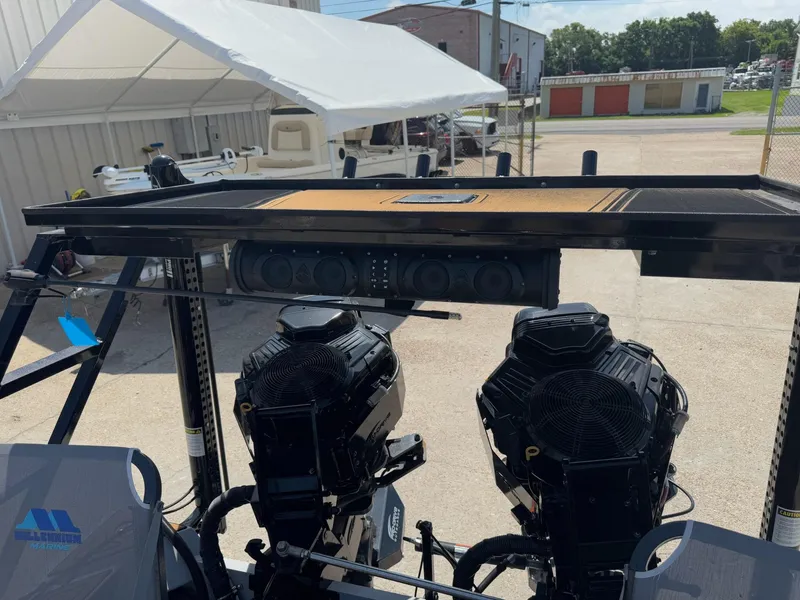 Slide: The Image of 2023 Pro-Drive 22x72 SBX boat with dual engines and sound system, parked outdoors. - 33