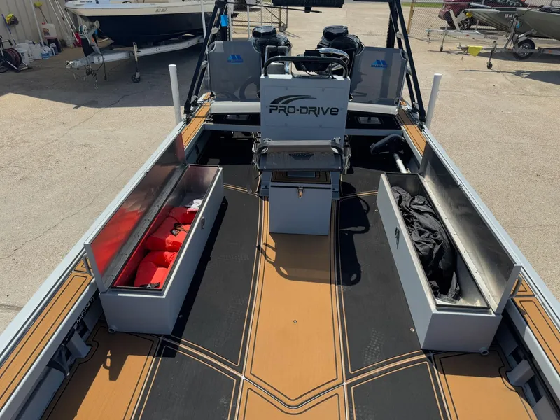 Slide: The Image of 2023 Pro-Drive 22x72 SBX boat interior with storage compartments and safety gear. - 34