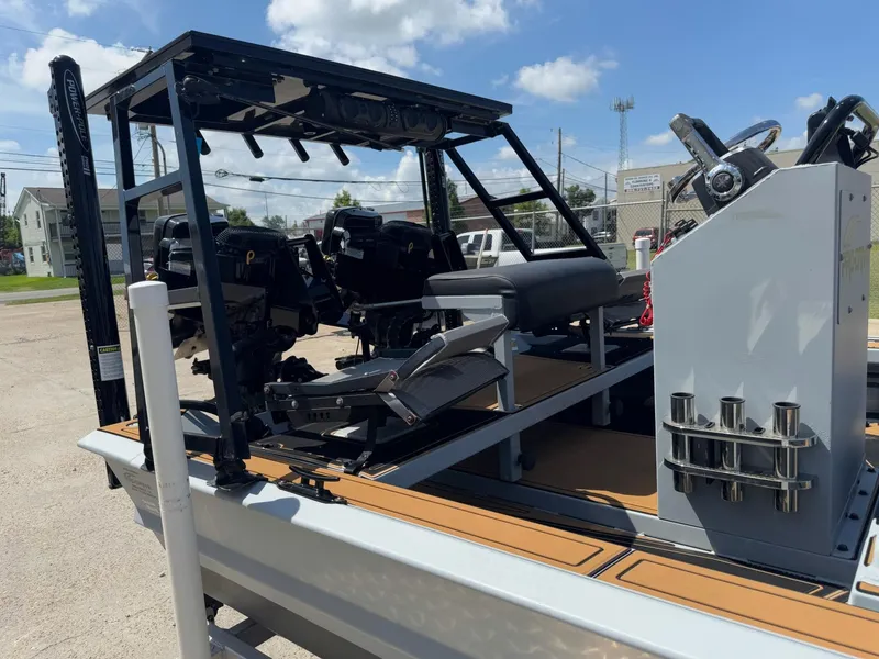 Slide: The Image of 2023 Pro-Drive 22x72 SBX boat with dual engines and modern console, parked outdoors. - 37