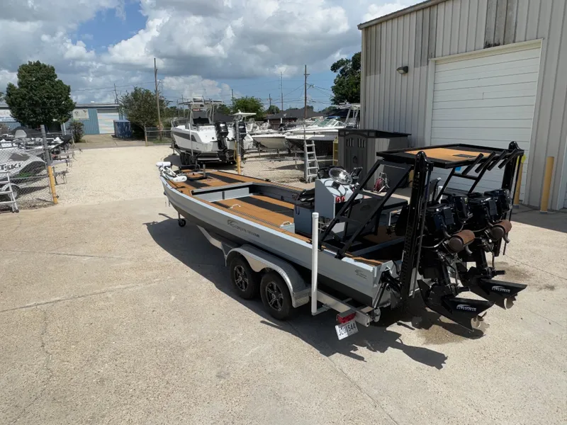 Slide: The Image of 2023 Pro-Drive 22x72 SBX boat on trailer, parked outside a warehouse. - 6