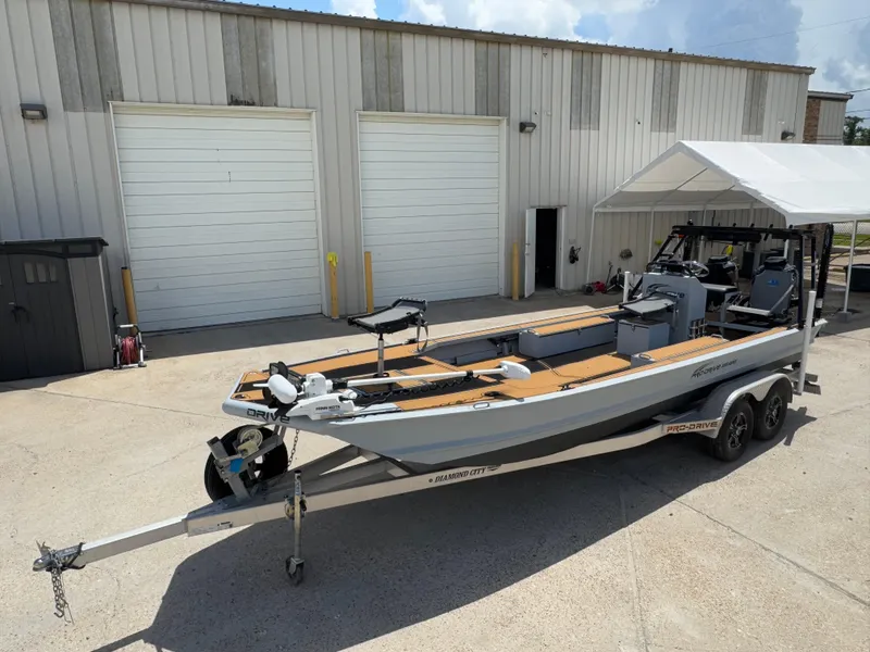 Slide: The Image of 2023 Pro-Drive 22x72 SBX boat on trailer outside a warehouse. - 7
