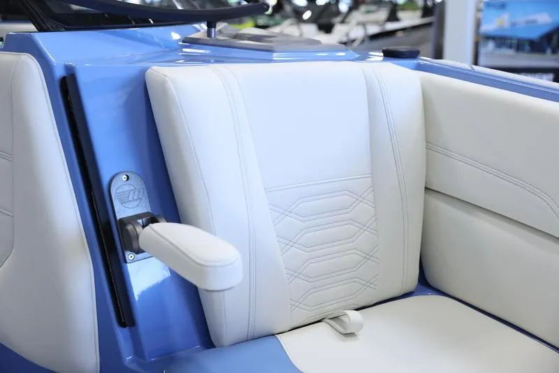 Slide: The Image of 2024 Malibu 26 LSV boat interior with white and blue seating. - 23