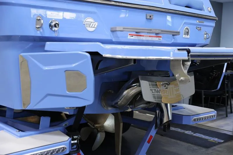 Slide: The Image of 2024 Malibu 26 LSV boat rear view showing propeller and exhaust system. - 3