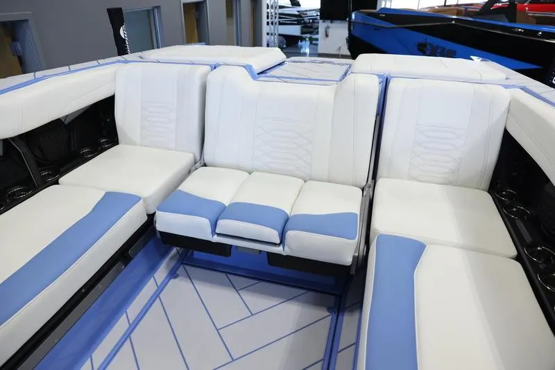 Slide: The Image of 2024 Malibu 26 LSV boat interior with white and blue seating. - 30