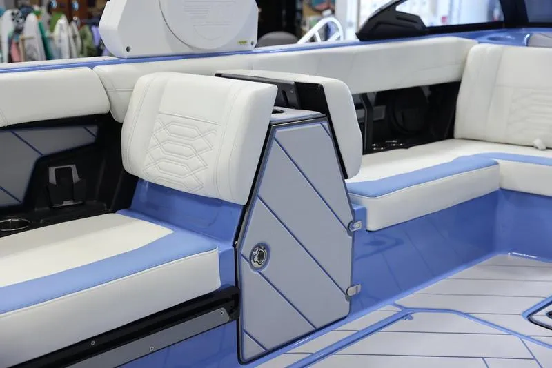 Slide: The Image of 2024 Malibu 26 LSV boat interior with white and blue seating. - 33