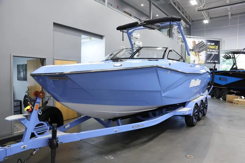 Slide: The Image of 2024 Malibu 26 LSV boat in showroom on trailer. - 5