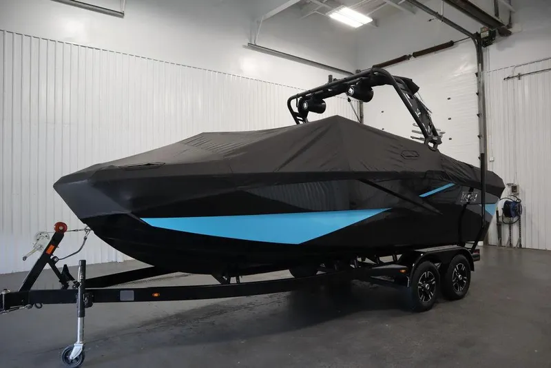 Slide: The Image of 2024 Heyday H22 boat on trailer with black cover in indoor storage. - 27