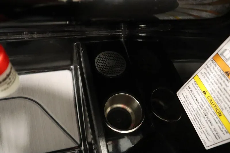 Slide: The Image of 2024 Heyday H22 boat interior detail with cup holders and caution label. - 28