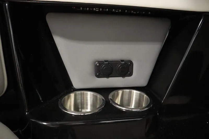 Slide: The Image of 2024 Heyday H22 boat interior with dual cup holders and power outlets. - 33