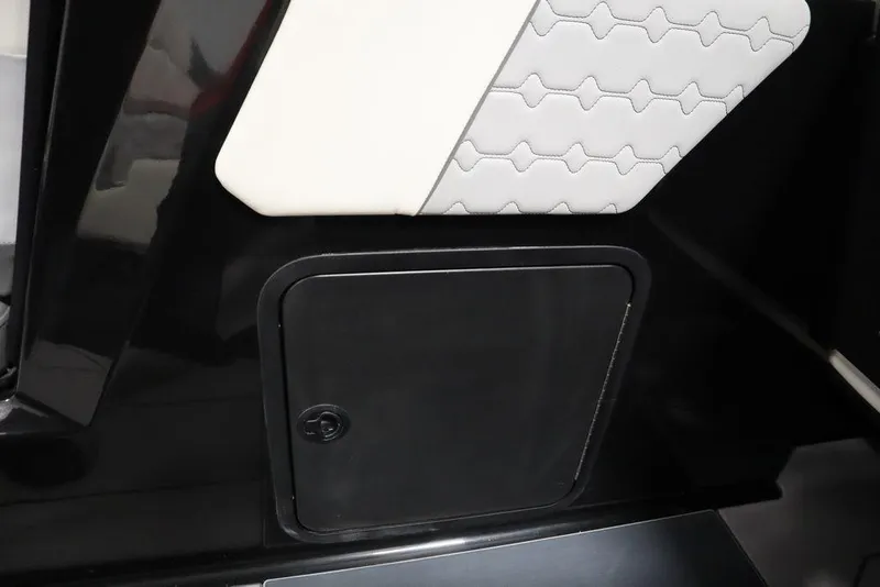 Slide: The Image of 2024 Heyday H22 boat interior storage compartment with black and white upholstery. - 36