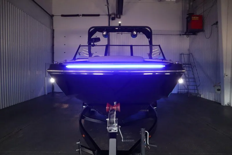 Slide: The Image of 2024 Heyday H22 boat with blue LED lights in a storage facility. - 41