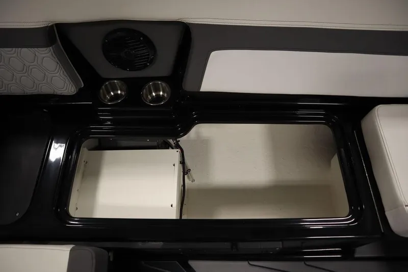 Slide: The Image of 2024 Heyday H22 boat interior storage compartment with cup holders and speaker. - 8