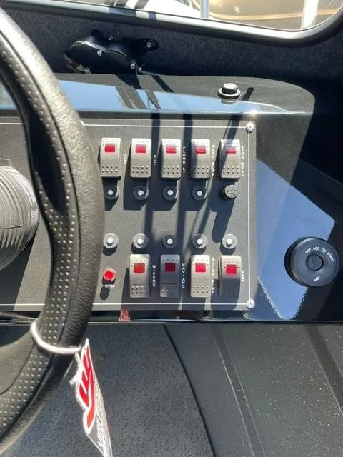 Slide: The Image of Dashboard of 2024 Spartan 220 Maximus with control switches and steering wheel. - 11