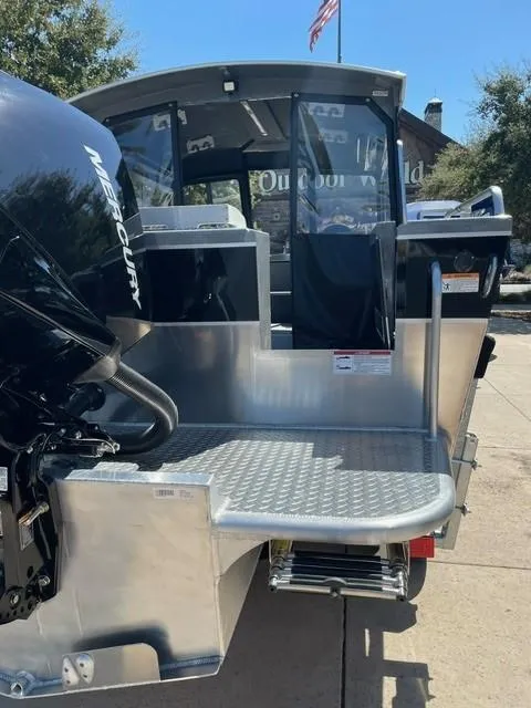 Slide: The Image of 2024 Spartan 220 Maximus boat with Mercury engine, outdoor setting. - 3