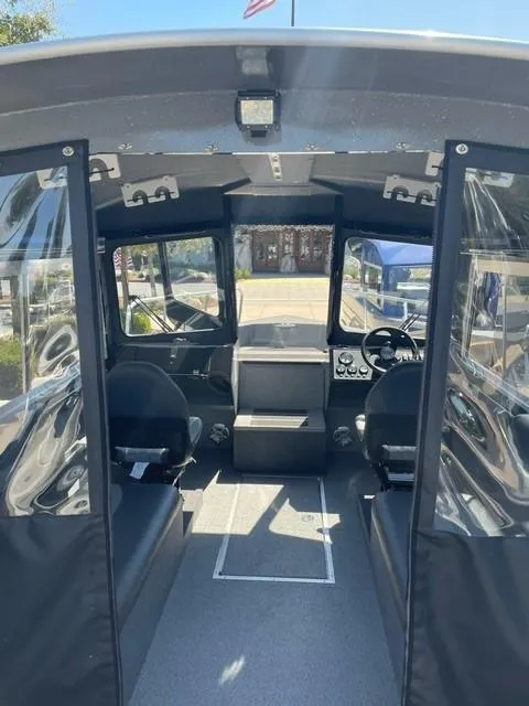Slide: The Image of Interior view of 2024 Spartan 220 Maximus boat, featuring spacious seating and modern controls. - 6