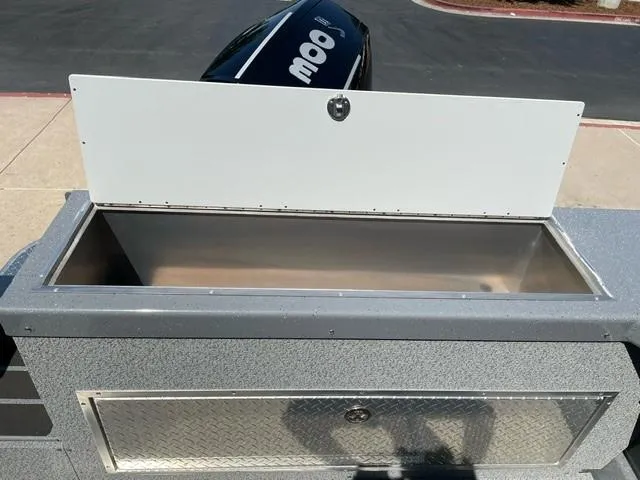 Slide: The Image of Open storage compartment on 2024 Spartan 220 Maximus boat, featuring durable construction. - 8
