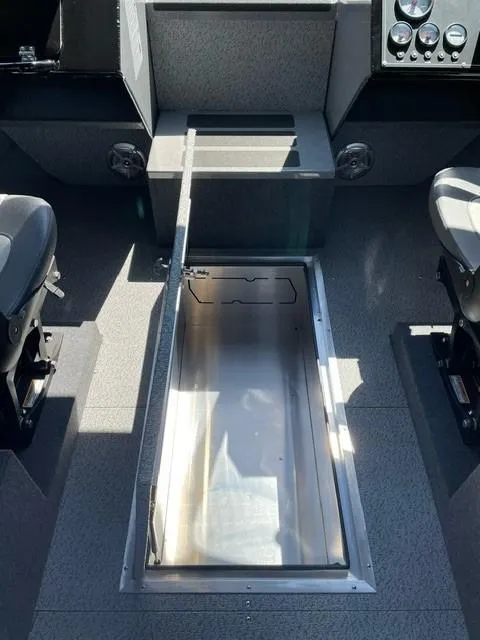 Slide: The Image of 2024 Spartan 220 Maximus boat interior with open storage compartment. - 9