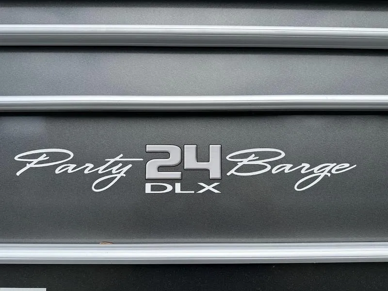 Slide: The Image of Sun Tracker Party Barge 24 DLX 2021 model logo on boat exterior. - 10