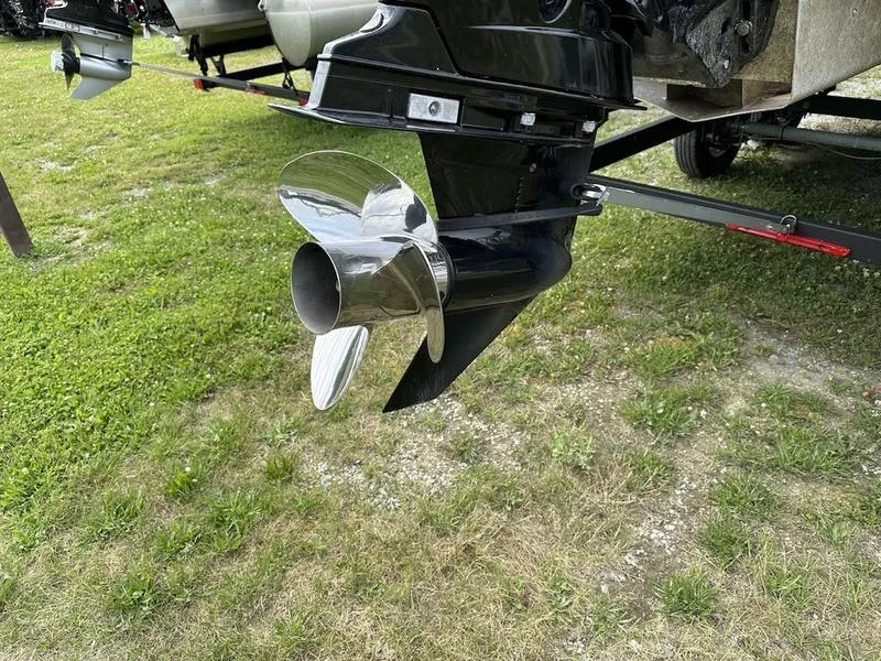 Slide: The Image of 2021 Sun Tracker PB 24 DLX boat propeller on grassy surface. - 11