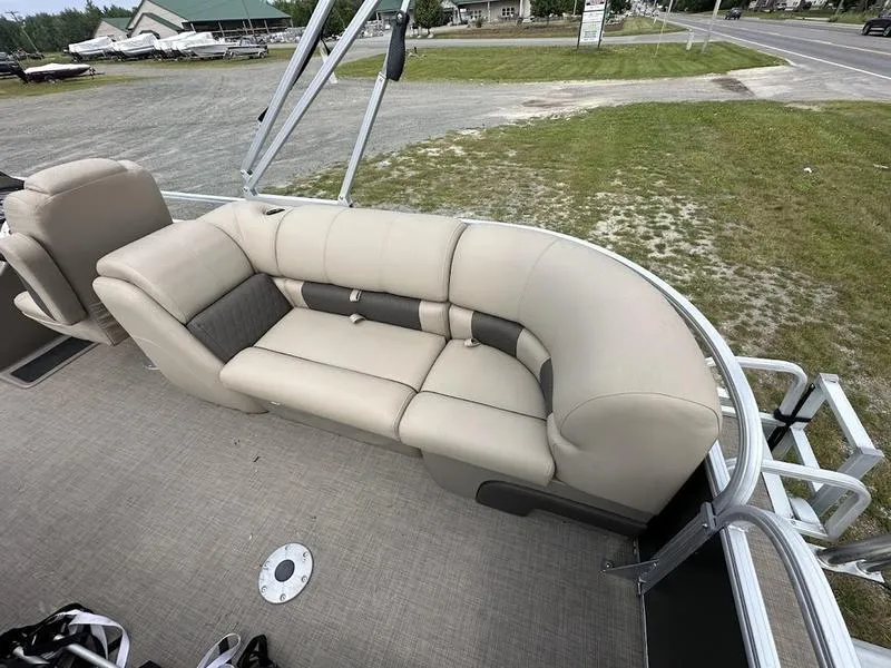 Slide: The Image of 2021 Sun Tracker PB 24 DLX pontoon boat with beige seating and spacious deck. - 5