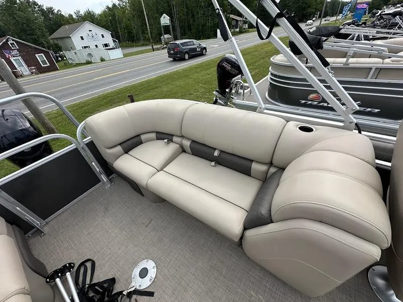 Slide: The Image of 2021 Sun Tracker PB 24 DLX pontoon boat with beige seating and spacious deck. - 6