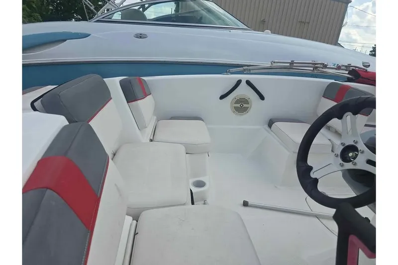 Slide: The Image of 2020 Tahoe T16 boat interior with white and gray seating, steering wheel, and speaker. - 4