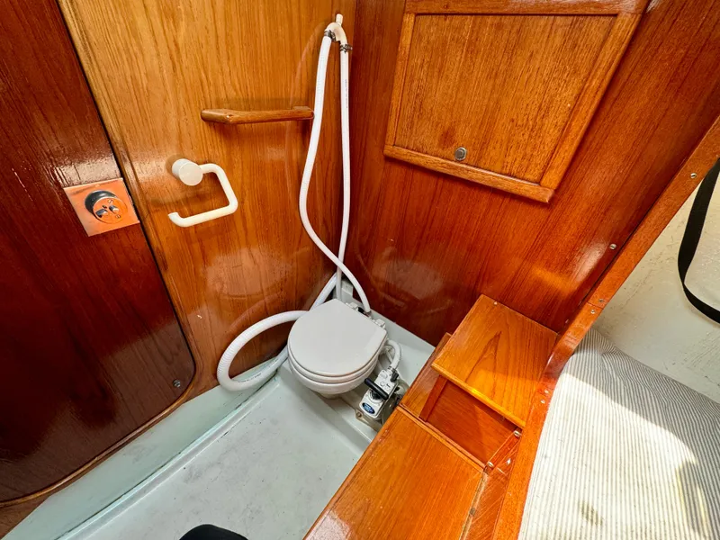 Slide: The Image of Interior of 1988 Beneteau First Class 12 sailboat with wood finish and seating area. - 16