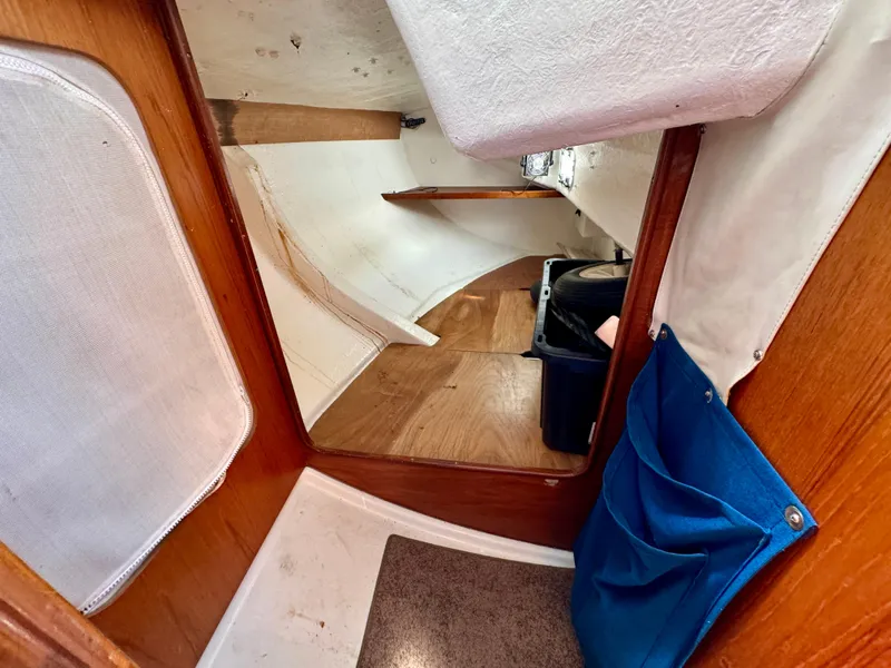 Slide: The Image of 1988 Beneteau First Class 12 yacht interior with navigation station and seating area. - 19