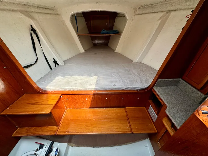 Slide: The Image of 1988 Beneteau First Class 12 yacht bathroom with wooden interior and compact toilet. - 21