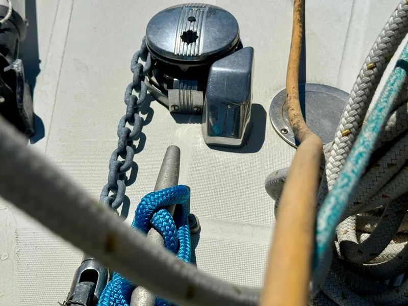 Slide: The Image of Deck equipment on a 1988 Beneteau First Class 12 sailboat, featuring ropes and a chain. - 27
