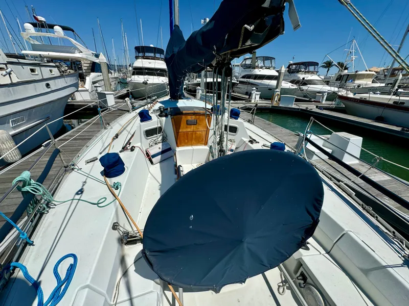 Slide: The Image of 1988 Beneteau First Class 12 sailboat docked in a calm marina. - 3